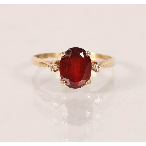 65 - 9 carat yellow gold ruby and diamond three stone ring; ring size O; 2.2g gross weight