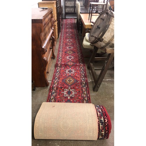 530 - Large and long red ground  stair carpet; approximately 1524cm long; 69cm wide