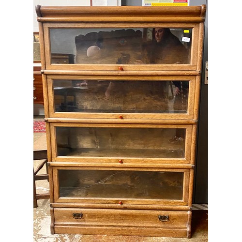 478 - Globe Wernicke oak four section bookcase; with drawer plinth base; 134cm high