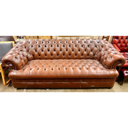 504 - Brown leather Chesterfield settee; 226cm long