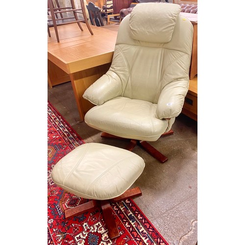 526 - Green leather easy chair with matching foot stool