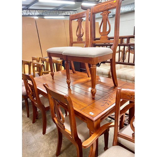 489 - Carved pine effect dining table; with six matching chairs (2 carvers and 4 singles)