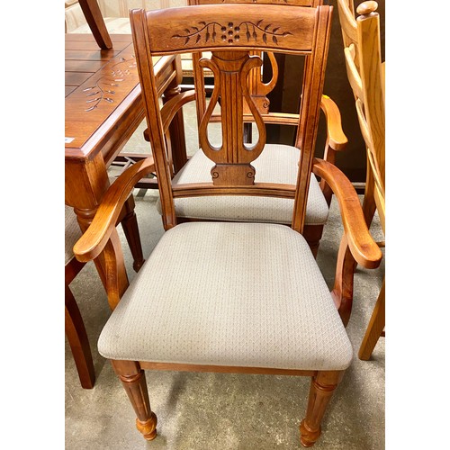 489 - Carved pine effect dining table; with six matching chairs (2 carvers and 4 singles)