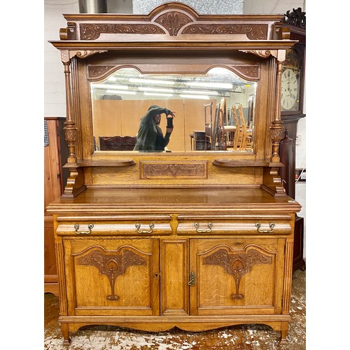 477 - Victorian carved oak mirror back sideboard; with two drawers and two cupboard doors; raised on outsw... 