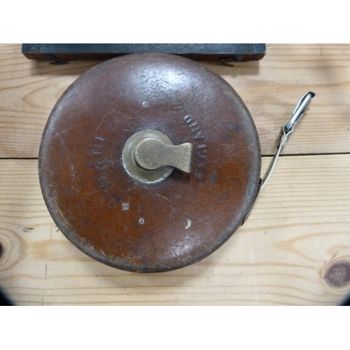 106 - Set of Victorian drawing instruments in a rosewood case and a tape measure.  (2)