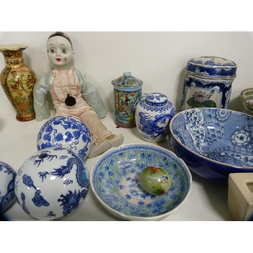 164 - Canton famille rose bowls, blue and white carpet-style bowls, vases and covers, dolls, Buddha figure... 