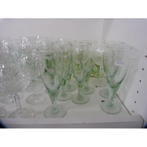 179 - Assorted drinking glasses to include liqueur, wine, also a celery vase etc (one shelf).