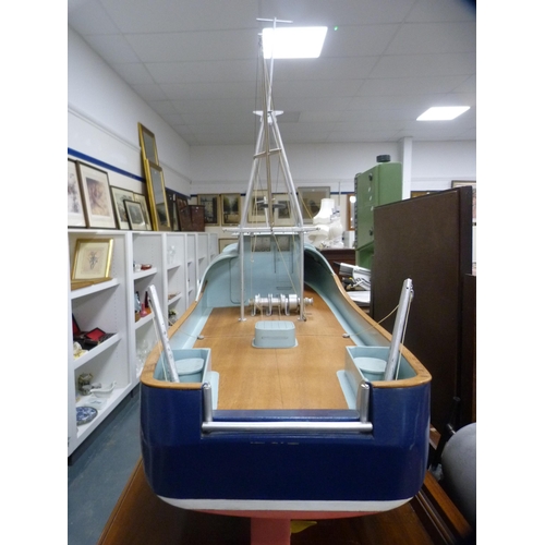 210 - Painted wooden model boat on stand.