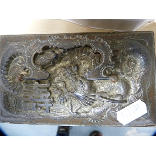 22 - Oriental copper and metal dragon relief decorated box and a Black Forest-style ebonised casket.  (2)