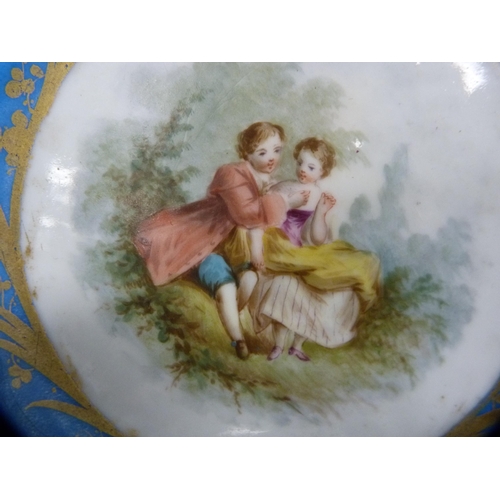 273 - Sèvres-style plate decorated with an 18th century couple to the well and a blue and gilt border, int... 