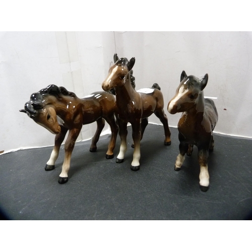 288 - Beswick figure of a donkey and three Beswick foals.  (4)