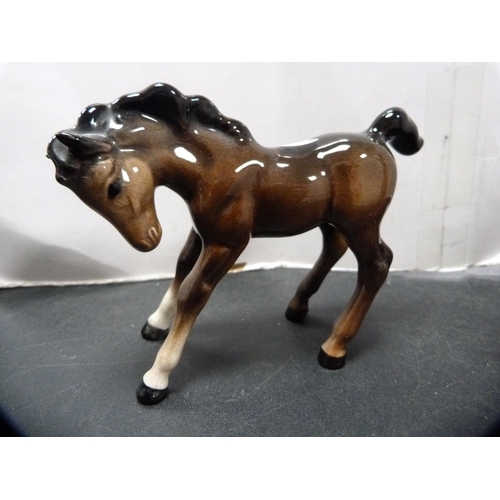 288 - Beswick figure of a donkey and three Beswick foals.  (4)