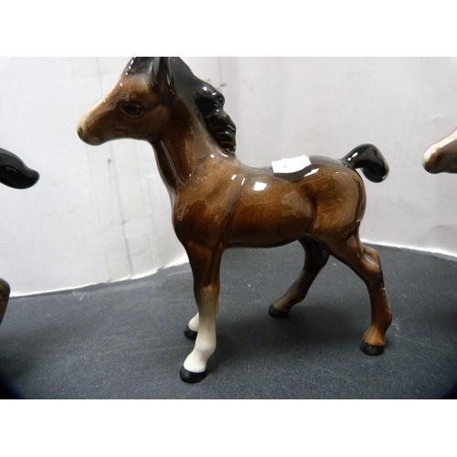 288 - Beswick figure of a donkey and three Beswick foals.  (4)