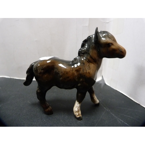 288 - Beswick figure of a donkey and three Beswick foals.  (4)