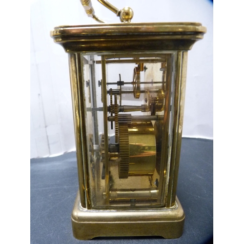 291 - Brass four glass carriage clock retailed by Matthew Norman, London, with key.