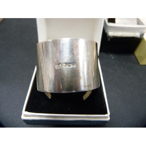 310 - Three assorted silver napkin rings, all cased, 92.3g.