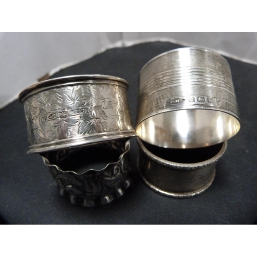 311 - Five assorted silver napkin rings, 103g gross, and a small silver-mounted photograph frame.  (6... 