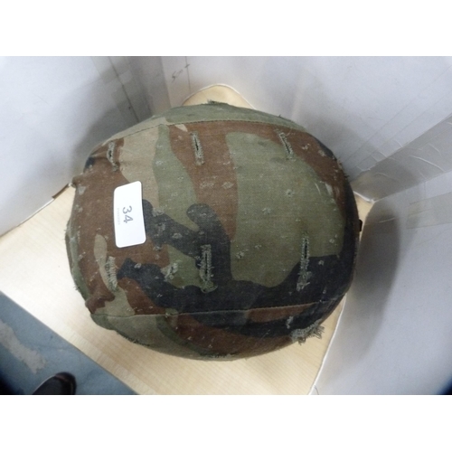 34 - USA ground troop's (Type 1) military helmet with camouflage cover.