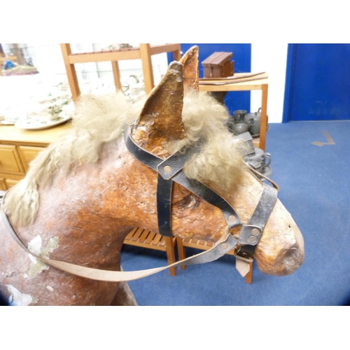 42 - Large plaster rocking horse on a wooden cradle support.