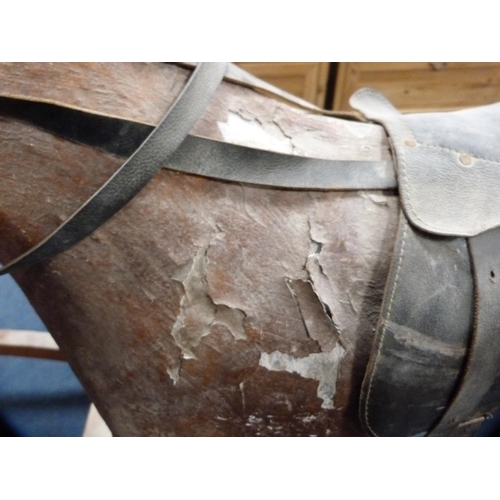 42 - Large plaster rocking horse on a wooden cradle support.