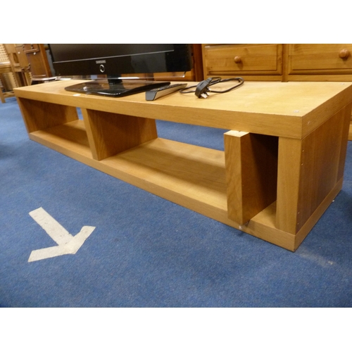 508 - Large Samsung flatscreen television with remote on a contemporary oak-effect television stand.