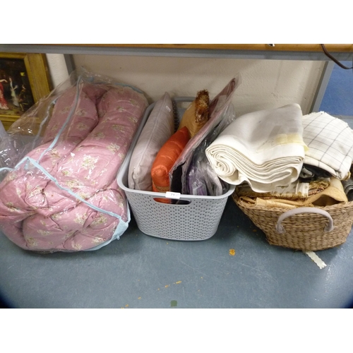 71 - Wicker basket containing a floral decorated quilt, cushions, cushion covers, fabric and napery etc.