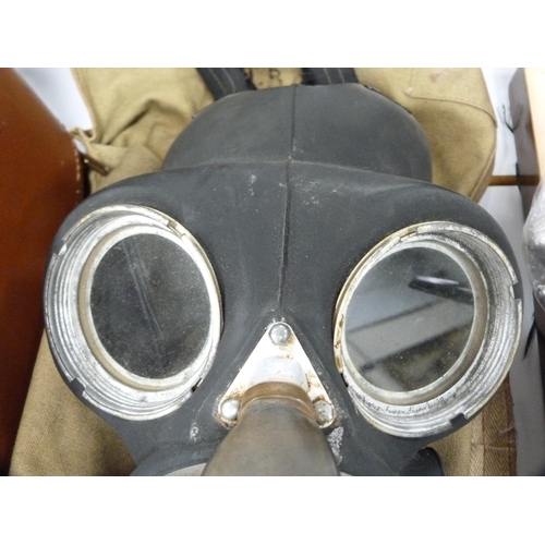 82 - WWII period Norman gas mask contained in a khaki canvas carry bag.