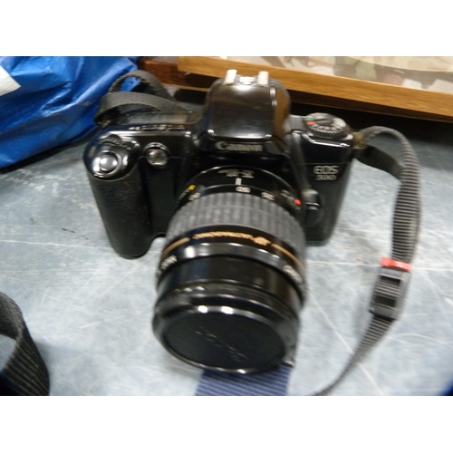 99 - Canon EOS 500 camera with a Sigma lens, cased, Jessops lens, light meter, tripod, accessories etc.