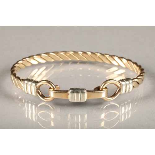 81A - 9 carat yellow and white gold bangle; 36g gross weight