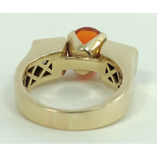 170C - Gold ring with oval fire opal flanked by eight pavé set princess cut diamonds, probably '18k'... 