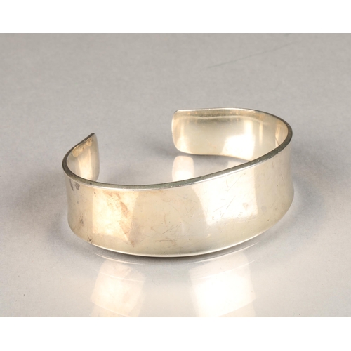 110 - Georg Jensen, a Danish modernist sterling silver torque bangle of slightly concave form, model No 18... 