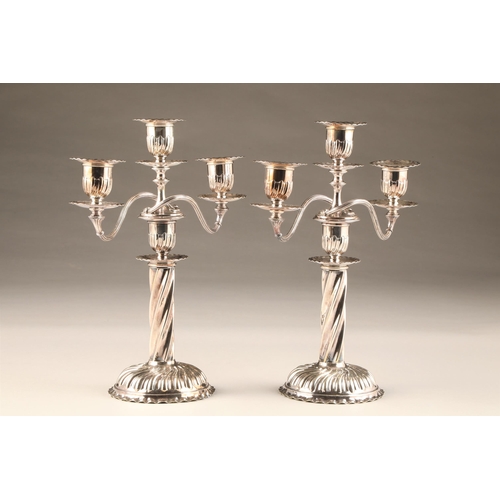 214 - Pair electro plated silver three light candelabra, spiral twist circular base and 
columns, height 3... 