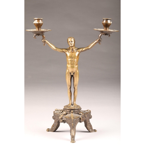 228 - Early 20th Century bronze twin light candle stick, modelled on a naked man with outstretched arms, r... 