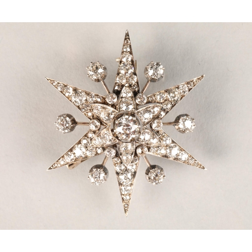 40 - Victorian diamond encrusted star burst brooch, central diamond 0.75 carat, mounted on white metal wi... 
