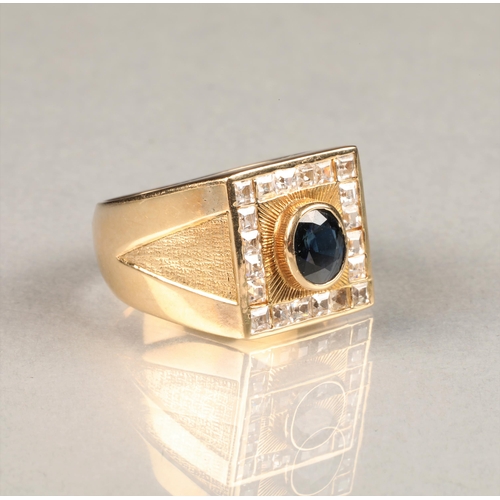 46 - Gents 14 carat yellow gold dress ring, square faced with a central oval blue stone surrounded by a b... 