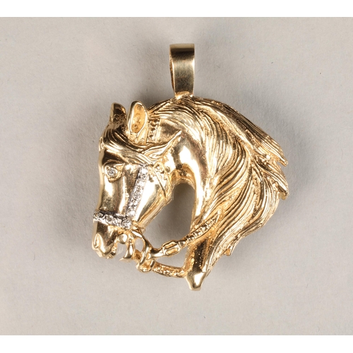 54 - 9 carat gold equestrian pendent in the form of a horse head, set with cubic zirconia's, weight 14g