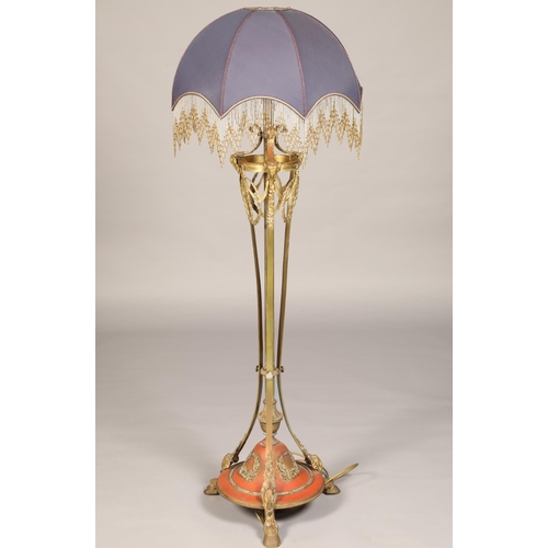 551 - Gilt metal standard lamp, Adam style, with applied rams head and floral garland and raised of hoof f... 