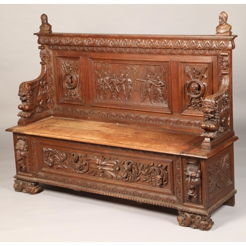 558 - Victorian carved oak settle/monks bench, with carved figure panelled back above, lift up seat flanke... 