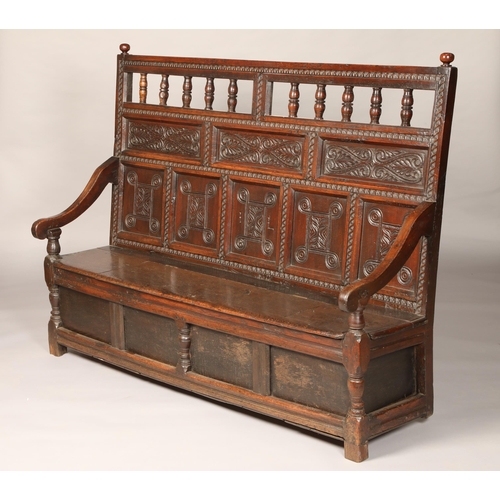 559 - Early 19th century carved oak box settle with five panel friezed back flanked scroll arms, length 16... 