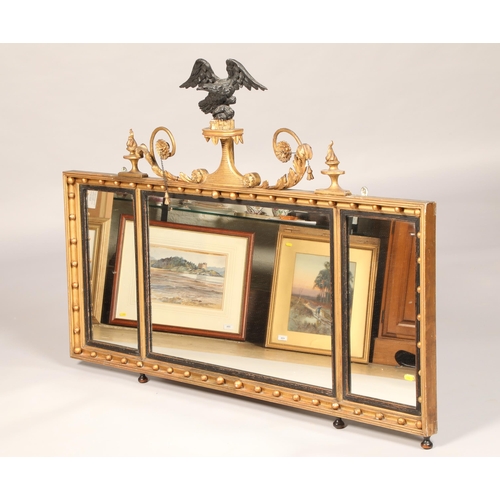 571 - Regency style triptych gilt mirror, with ebonised 
eagles finial, length 132cm, height 98cm