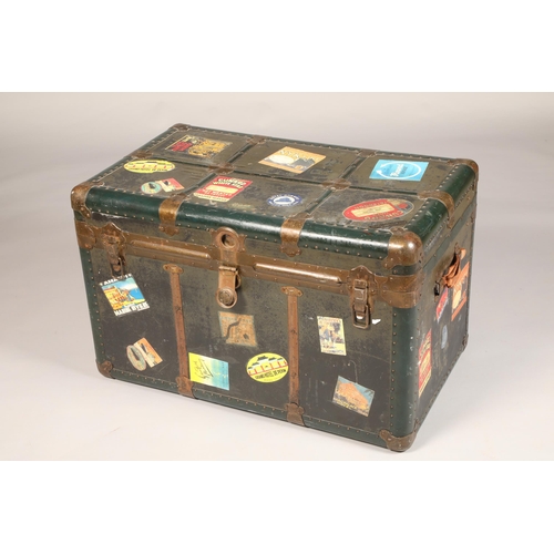 587 - Travel trunk  with various luggage labels, width 58cm, height 57cm