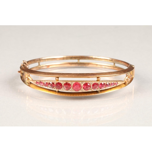 77 - 9 carat rose gold ruby stiff bangle set with thirteen graduated rubies
6.5cm diameter , weight 9g