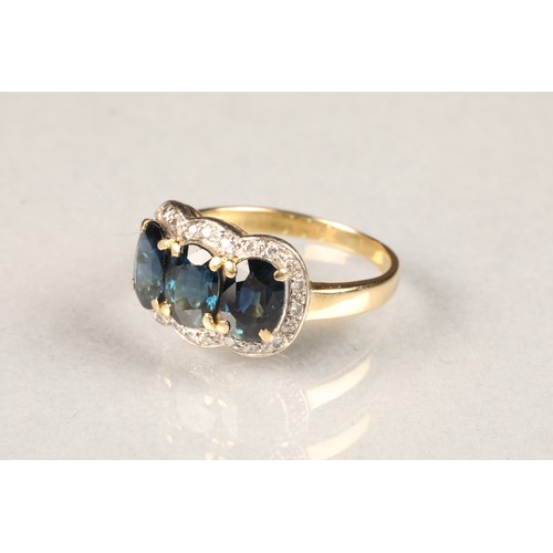 66 - 18 carat gold three stone sapphire ring, surrounded by diamonds. ring size M/N