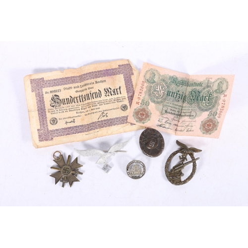 571 - German WWII items including an anti-aircraft Flak badge, a Wound Badge, an aluminium eagle and swast... 