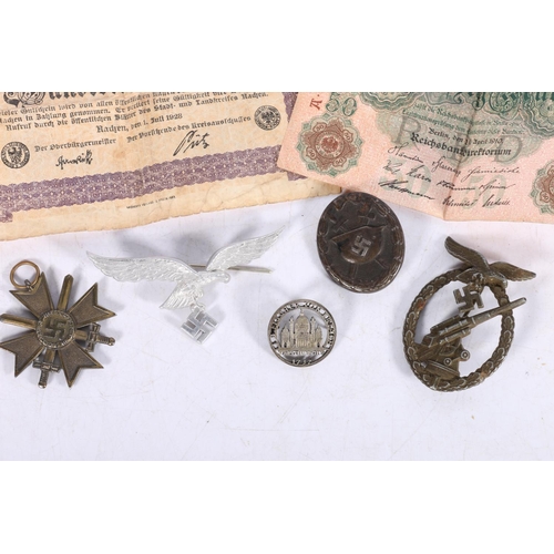 571 - German WWII items including an anti-aircraft Flak badge, a Wound Badge, an aluminium eagle and swast... 