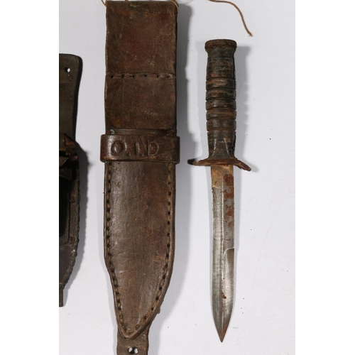 588 - Commando type dagger and two American style fighting knives. (3)