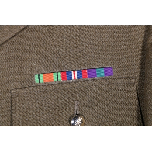 595 - British Army uniform, a WWII era khaki green woollen trench coat with interior pocket label Bernard ... 