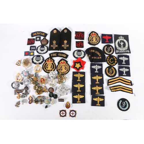 559 - A collection of badges, buttons etc. to include two Edinburgh City Police enamel badges, Royal Scots... 