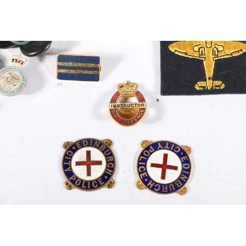 559 - A collection of badges, buttons etc. to include two Edinburgh City Police enamel badges, Royal Scots... 