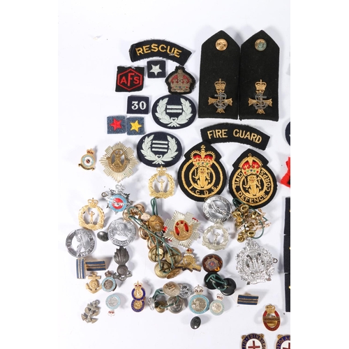 559 - A collection of badges, buttons etc. to include two Edinburgh City Police enamel badges, Royal Scots... 